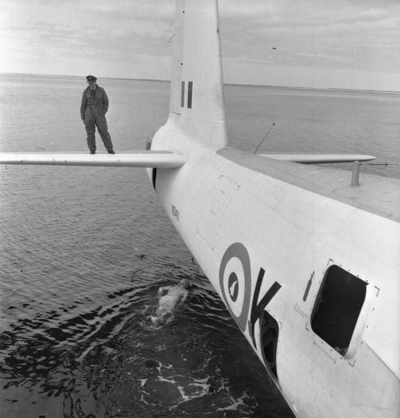 Salvage of Maritime Operational Conversion Unit Sunderland, NZ4111, after it was holed and sank in Te Whanga Lagoon, Chatham Islands.
Wing Commander Henry Lionel Homer, Director of Aircraft Engineering, doing an exterior underwater inspection of the Sunderland, while Squadron Leader Robert Emery Weston (?) watches from the starboard horizontal stabiliser.
NB. this negative deteriorating resulting in poorer image quality.
