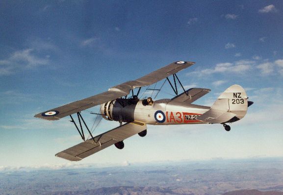 Air to air view of Avro 626 NZ203 in flight over hills after being fully restored.
