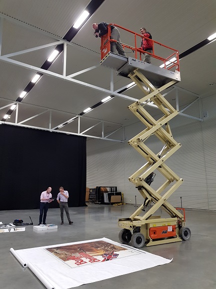 Photographing the Battle of Britain film promotional poster at the Air Force Museum of New Zealand.