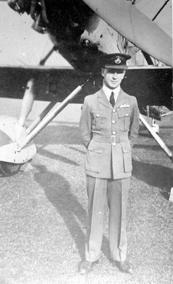 Formal full length portrait of William Foster in service dress uniform in front of a Vildebeest at RNZAF Station Wigram. Image ref ALB8553819D, Air Force Museum of New Zealand.