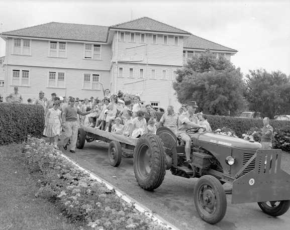 Children's Christmas parties have long been a highlight for Air Force families. Here, children are going for a ride with Santa Claus at the RNZAF Hobsonville Sergeants' Mess children's Christmas party, 1958. Image ref WhG14241-58, RNZAF Official.