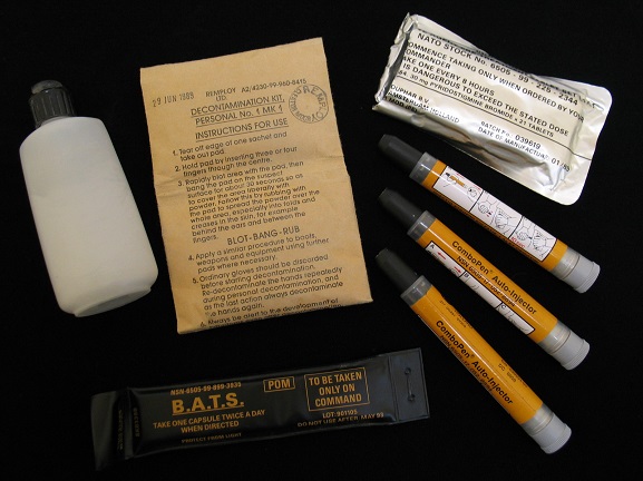 Personal NBC (Nuclear/Biological/Chemical) Warfare Kit, issued to Warrant Officer Pat MacKay during the 1991 Gulf War. Kit consists of olive green carry case containing: rubber gloves with cotton inners; three 