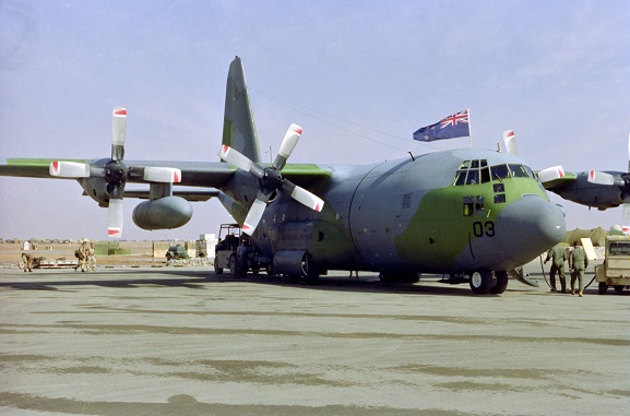 No. 40 Squadron Hercules NZ7003 with a New Zealand flag flying from the cockpit hatch. Presumed to be at King Khalid International Airport, Riyadh, Saudi Arabia, Feb-Mar 1991. Image ref PD29-10-91, RNZAF Official.