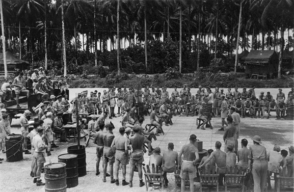 Image from the Keith Hubert Kendon personal album collection.  Military personnel horse racing using wooden horses.  Bougainville, 1945. Image ref ALB940767056, Air Force Museum of New Zealand.