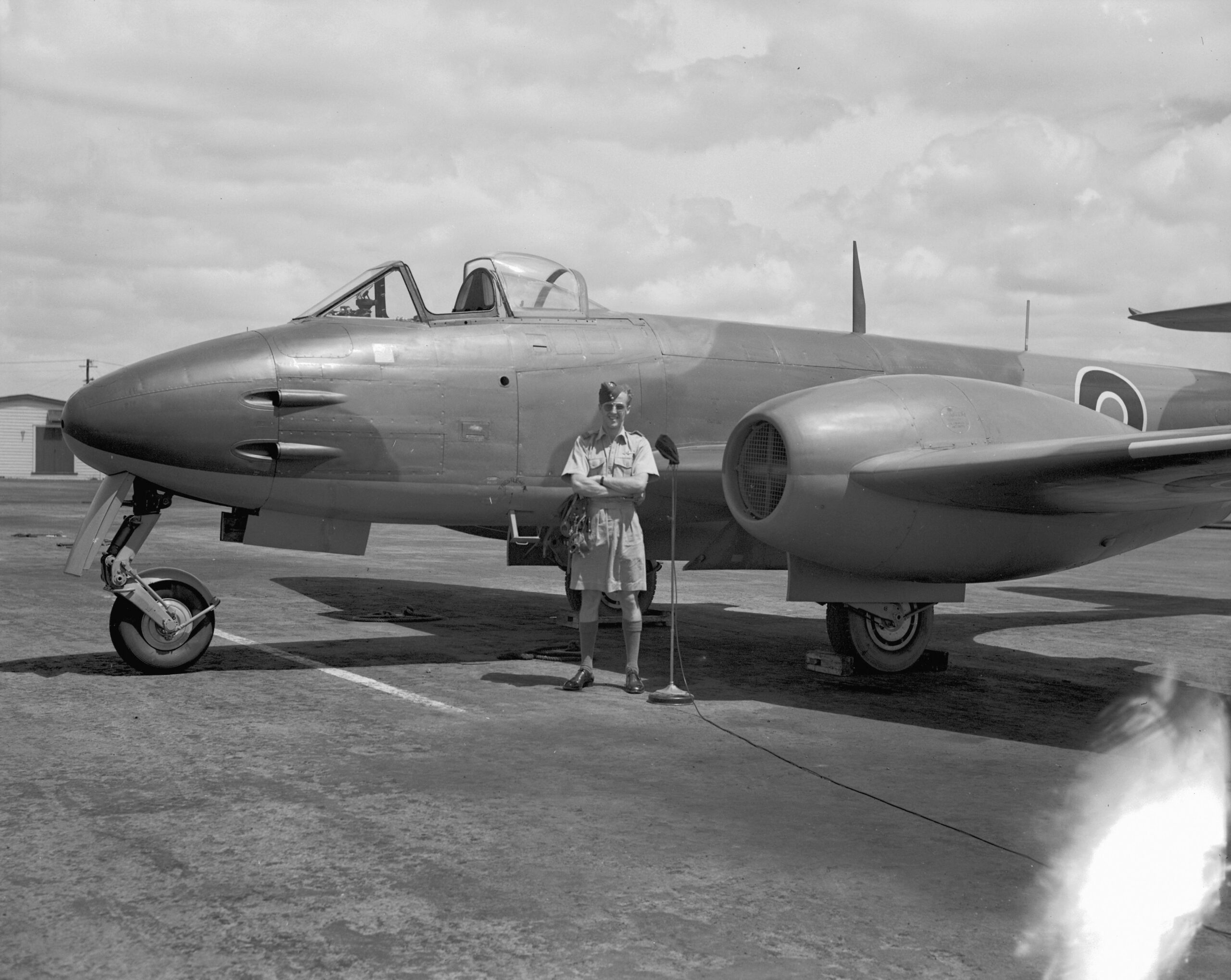 Arrival of Meteor NZ6001 at RNZAF Station Ardmore at the start of a tour of New Zealand, flown by Squadron Leader RM McKay, pictured here standing beside his aircraft. 15 February 1946. Image ref ArdG1155_46, RNZAF Official.