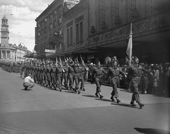 No. 14 Squadron parading along Queen Street, Auckland, past the dais with dignitaries outside the Civic Theatre, before leaving for Japan for Occupation duties. 7 March 1946. Image ref ArdG1173-46, RNZAF Official.