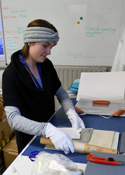 Archives Technician, Louisa Hormann, packing a collection of papers at the Air Force Museum of New Zealand. Image ref MUS21109, Air Force Museum of New Zealand.