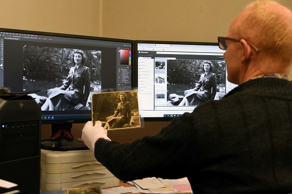 Keeper of Photograph, Matthew O'Sullivan, digitising a photograph in the archives at the Air Force Museum of Zealand. Image ref MUS21110, Air Force Museum of New Zealand.