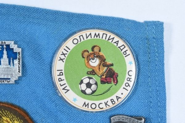 Close up of Misha the Bear badge