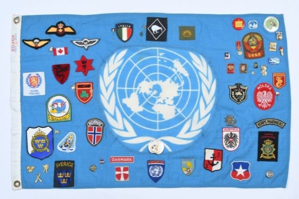 United Nations flag with badges and patches