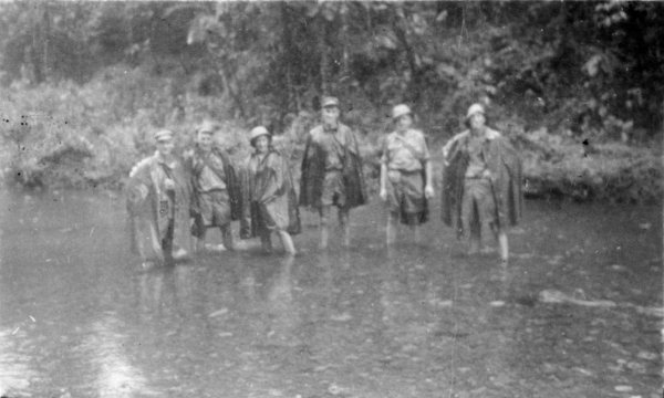 6-men-standing-in-river-water