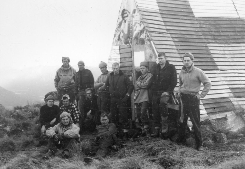 people-by-a-frame-hut